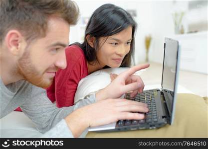 a couple is on laptop