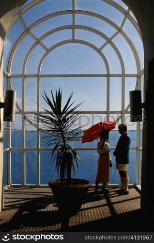 A couple is seen conversing near a plant, Bermuda portfolio, Bermuda