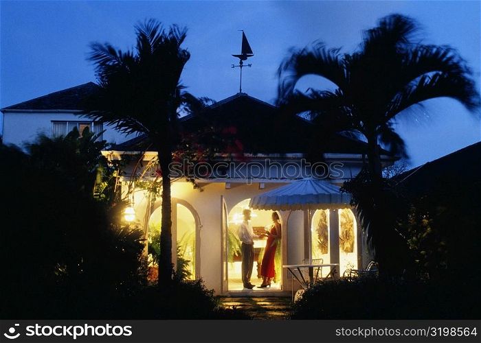 A couple is seen standing at the door of Bon Vivant Villa, Barbados, Caribbean