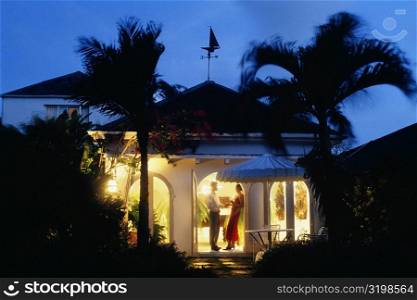 A couple is seen standing at the door of Bon Vivant Villa, Barbados, Caribbean