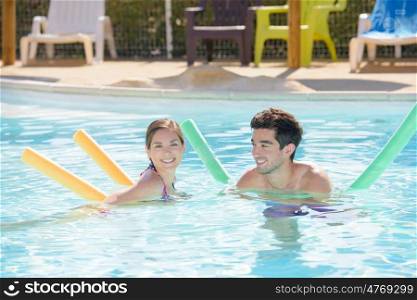 a couple is swimming outdoors