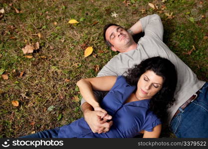 A couple laying on grass dreaming - sharp focus on female