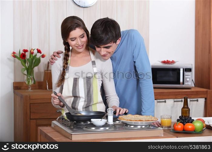 A couple making crepes.