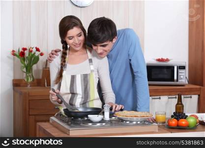A couple making crepes.