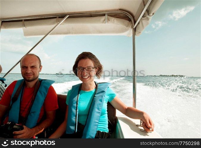 A couple of happy tourists on a speedboat