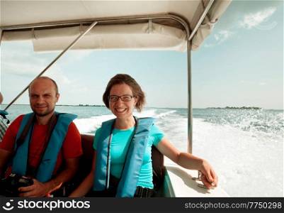 A couple of happy tourists on a speedboat
