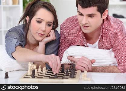 A couple of teenagers playing chess.