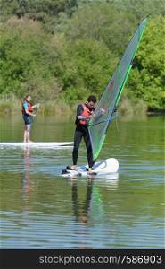 a couple of windsurfer on the lake