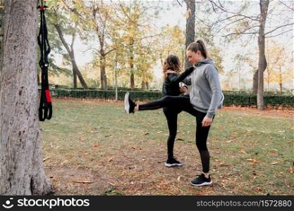 A couple of women training together outdoors in the park