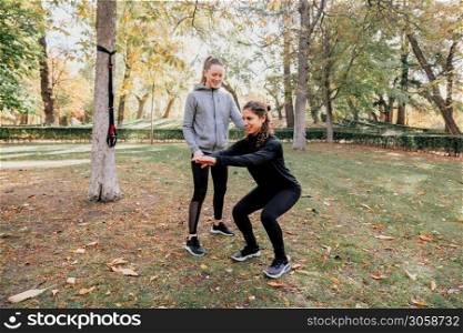 A couple of women training together outdoors in the park. A couple of women training outdoors in the park