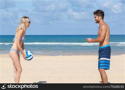 a couple playing beach volleyball