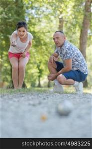 a couple playing the petanque