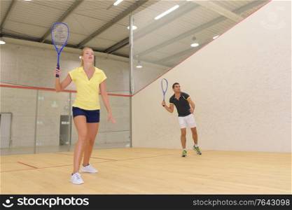 a couple plays tennis indoors