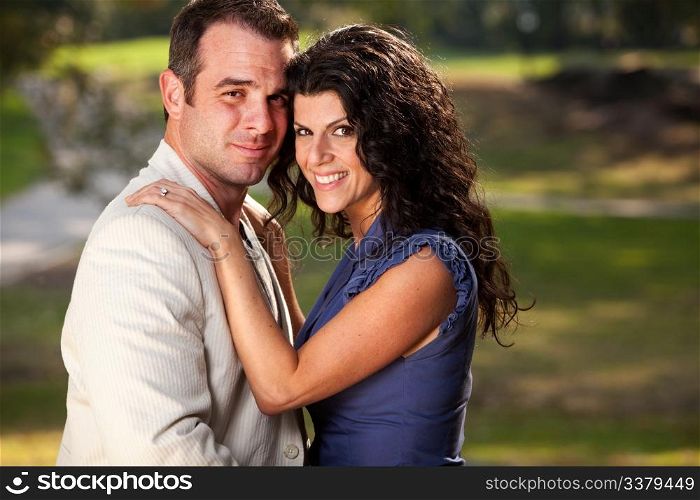 A couple posing for an engagement portrait
