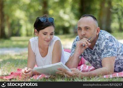 a couple sitting on grass