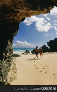 A couple takes a stroll on Horseshoe beach, Bermuda