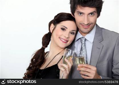 a couple toasting sparkling wine glasses