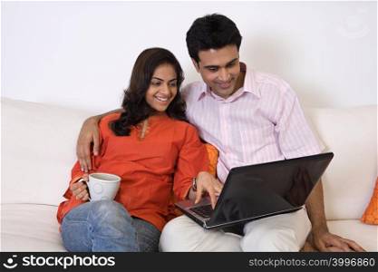 A couple using a laptop