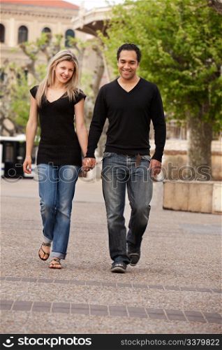 A couple walking outdoors in an urban landscape.