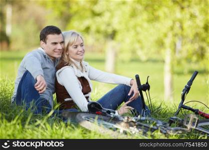 A couple with bikes in autumn park