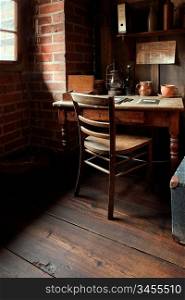 A cozy miller&acute;s room corner with wooden furniture and brickwalls in Malbork, Poland.