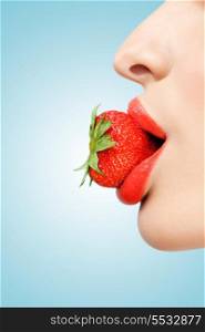 A creative portrait of a beautiful female face holding a red ripe strawberry in her sexy mouth.
