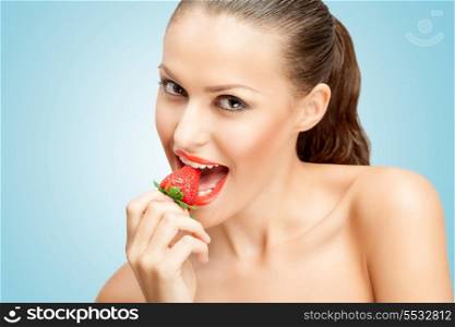 A creative portrait of a beautiful girl biting a red ripe strawberry sexually.
