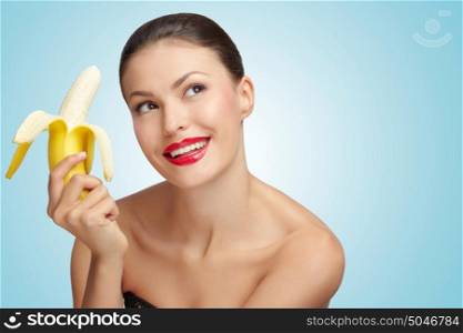 A creative portrait of a sexy woman holding a half-peeled yellow banana in her hand.