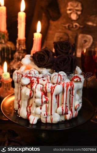 A creepy cake (red velvet) decorated with meringue bones and drenched in blood. Great Halloween idea.