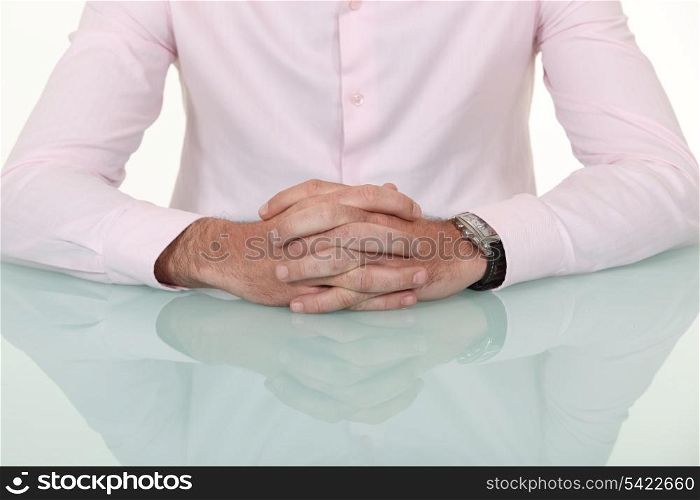 A cropped picture of a businessman&rsquo;s hands.