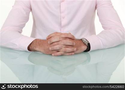 A cropped picture of a businessman&rsquo;s hands.