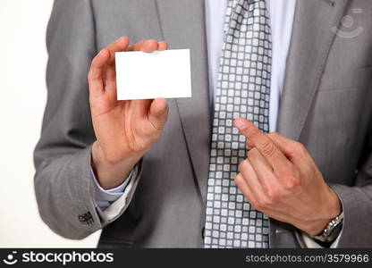 A cropped picture of a businessman showing his card.