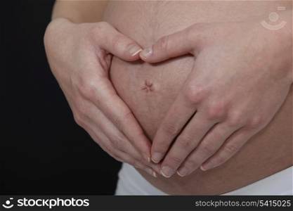 A cropped picture of a pregnant woman&rsquo;s belly.