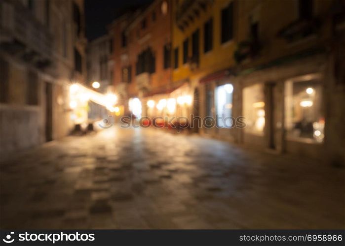 A crowd of people at the old town city night street defocused blurred abstract background
