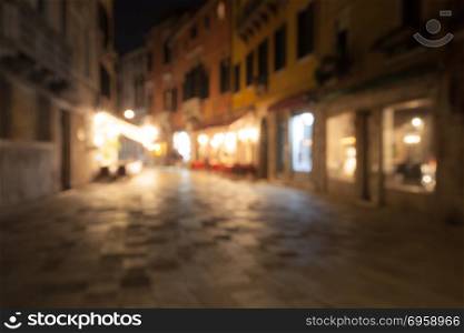 A crowd of people at the old town city night street defocused blurred abstract background