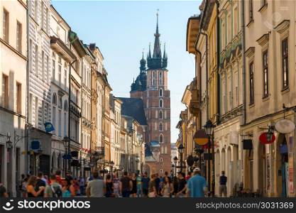 a crowd of tourists on Florian street, view of the Mariinsky chu. a crowd of tourists on Florian street, view of the Mariinsky church in the center of Krakow, Poland