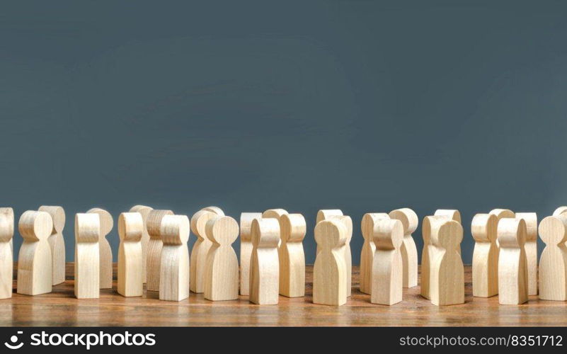 A crowd of wooden figures of people. society, demography. group of citizens, rally, political movement or electorate. Customers and buyers, statistics, preferences of Population. Employees. Copy space