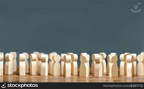 A crowd of wooden figures of people. society, demography. group of citizens, rally, political movement or electorate. Customers and buyers, statistics, preferences of Population. Employees. Copy space