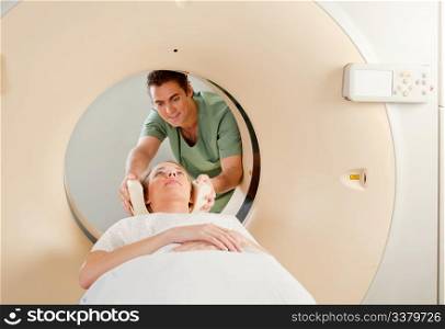 A CT Scan Technician preparing a patient for scanning