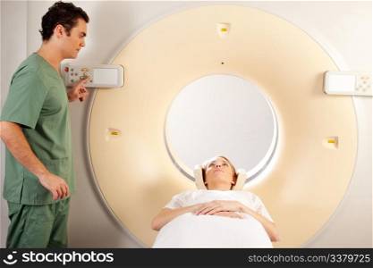A CT Scanner Technician preparing a patient for scanning