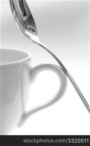 A cup and a spoon on a white background