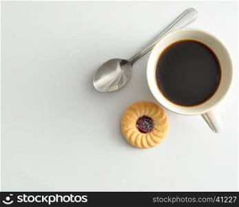 A cup filled with coffee and a round biscuit isolated on a white background