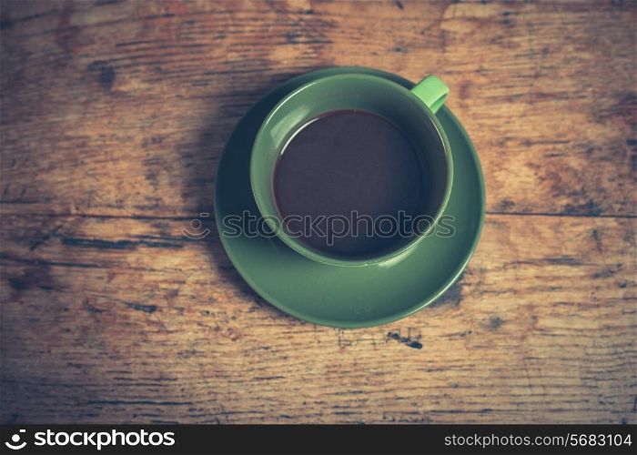 A cup of black coffee on a wooden table