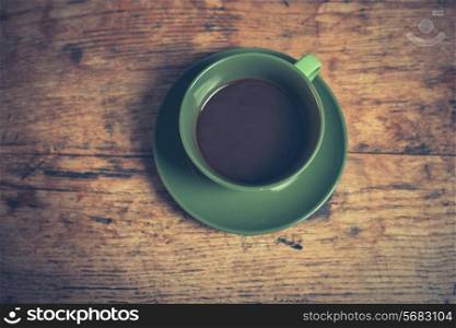 A cup of black coffee on a wooden table