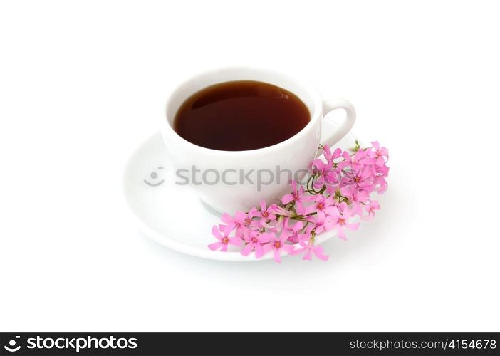 A cup of black coffee with flowers on a white background
