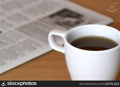 A cup of coffee and a newspaper