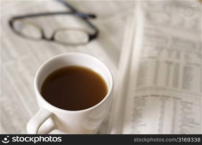 A cup of coffee and financial newspaper