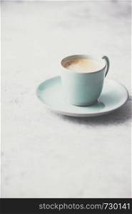 A cup of coffee on light grey background, coffee break concept. A cup of coffee on light grey background