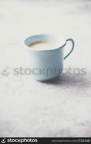 A cup of coffee on light grey background, coffee break concept. A cup of coffee on light grey background