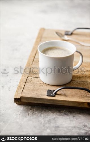 A cup of coffee on light grey background, coffee break concept